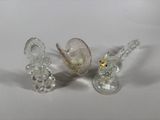 three glass figurines sitting next to each other on a table