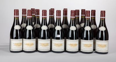 six bottles of wine are lined up in a row on a table