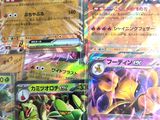 several pokemon cards are stacked on top of each other on a table