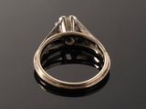 a close up of a ring on a table with a black background