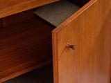 a wooden cabinet with a drawer underneath it