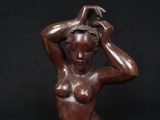 an image of a statue of a woman with her hands on her head