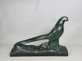 an image of a statue of a bird sitting on top of a leaf