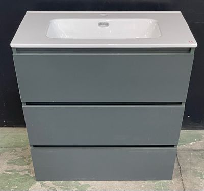 un lavabo blanc posé sur un meuble-lavabo gris