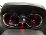 a car dashboard with a clock and a dash light