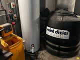 a tank that is sitting next to a yellow trash can