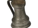 a silver pitcher with a handle on a white background