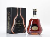 the bottle of hennessy xo is next to the box