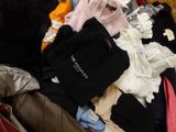 a pile of clothes that is sitting on the floor