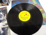 a black vinyl record sitting on a table next to other records