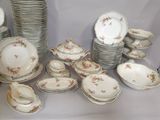 a lot of plates and bowls that are on a table