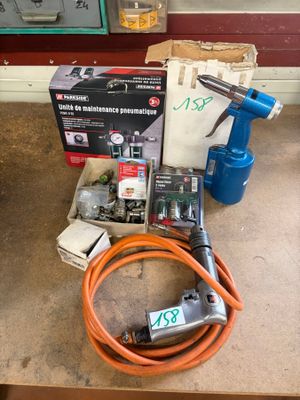a box of tools on a table next to a hose