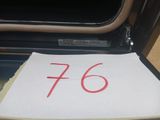 a piece of paper with the number 76 written on it