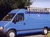 a blue van that is parked on the side of the road