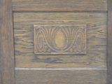 a close up of a wooden door with a decorative design