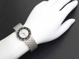 a woman ' s wrist with a watch on it on a mannequin hand