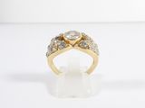 a close up of a diamond ring on a white surface