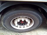 a flat tire on a flatbed truck parked on the side of the road