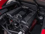 the engine of a red sports car with its hood open