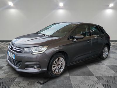 a grey citrole parked on a checkered floor in a garage