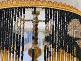 a lamp that is on a table with beads on it