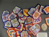 a pile of badges and a coin on a table