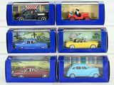 six toy cars are in a blue box on a white surface