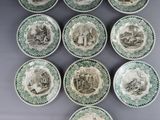 a set of six green and white plates with pictures of people on them