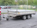 a truck with a trailer attached to it parked in a parking lot