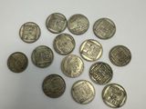a pile of silver coins sitting on top of a white surface