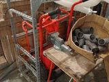 a basket of pipes and pipes on a cart in a warehouse