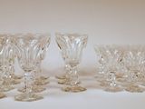 four clear glass wine glasses sitting on top of a white table
