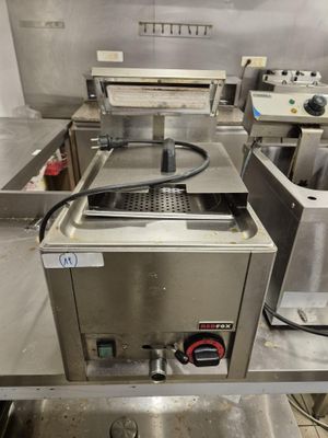 many machines that are in a kitchen with a lot of counter space