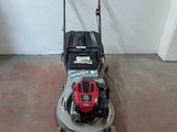 an image of a lawn mower parked in a garage