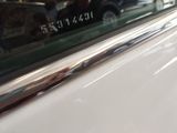 a close up of a car door handle with a sticker on it