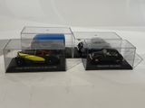two model cars in a display case on a white surface