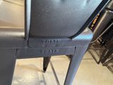 a close up of a metal table with a black chair