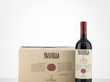 a bottle of wine sitting next to a cardboard box on a table