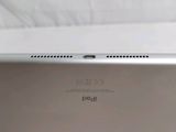 the back view of a silver ipad with a white background