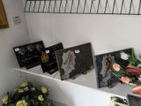 a shelf that has a bunch of pictures and flowers on it