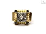 an image of a gold ring with black and white diamonds