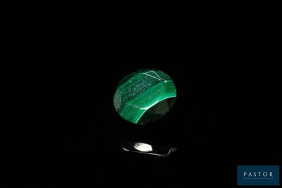 a picture of a green stone with a spoon in the dark