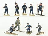 six figurines of men in uniforms with skis and poles