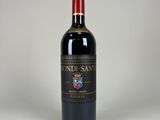 the bottle of wine is sitting on a white surface