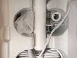 a white toilet with a toilet paper dispenser attached to it