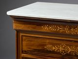 a marble top on a wooden chest of drawers