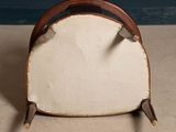 a white chair with a brown handle on the floor