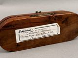 a small wooden box with a label on it