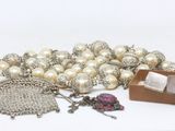 a lot of pearls and other jewelry on a table