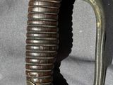 a close up of a sword with a blue handle